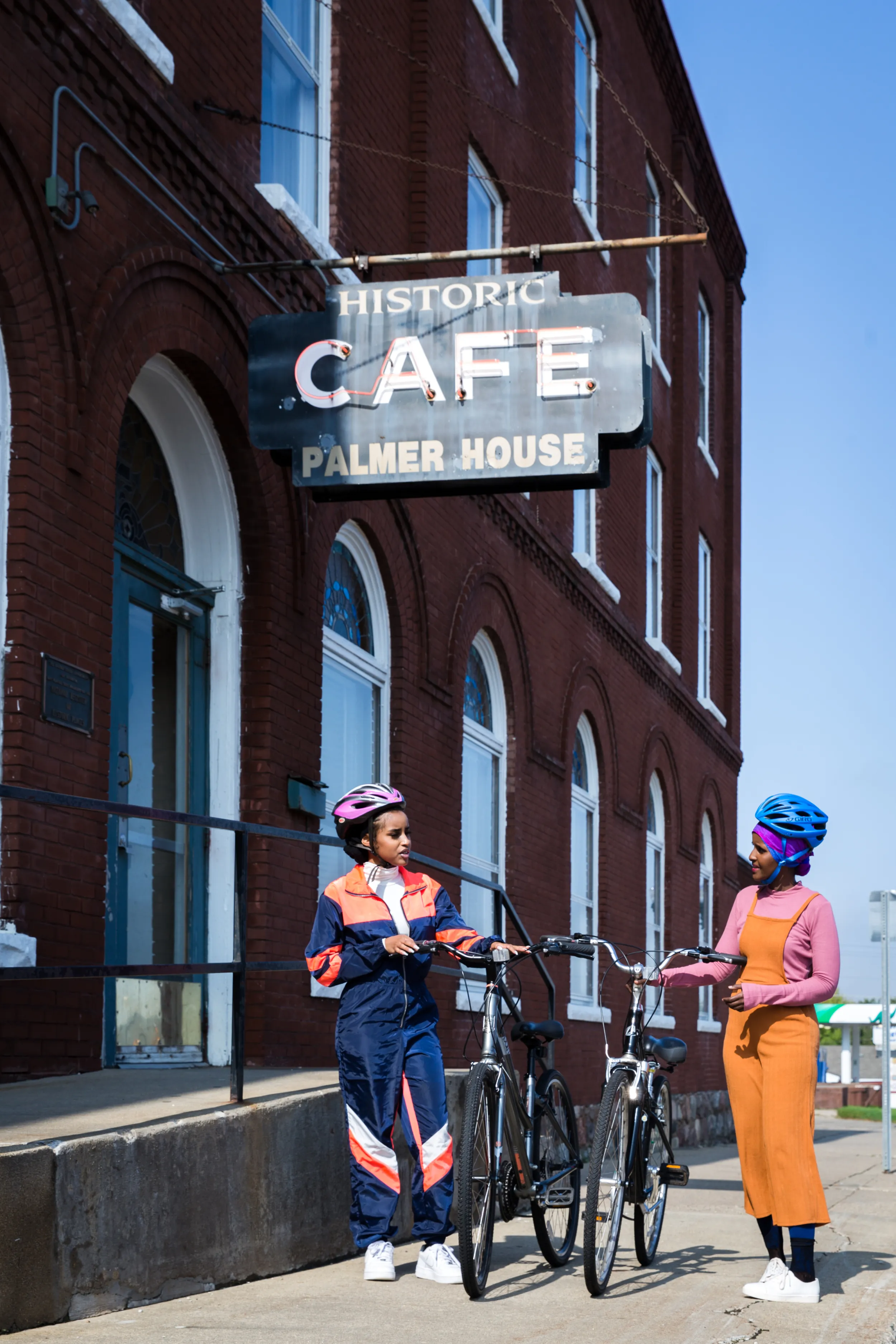 Two women pause in front of Palmer House Hotel
