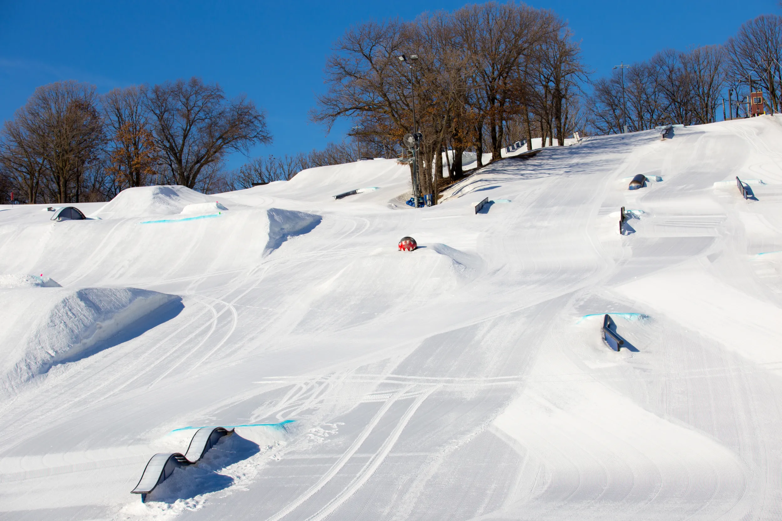 Ski hill with jumps and grind rails