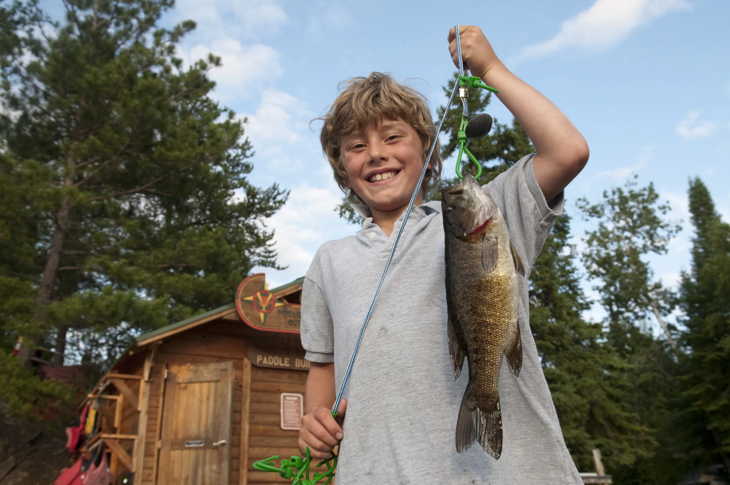 Josh catches a nice fish while fishing with Voyageur Canoe Outfitters