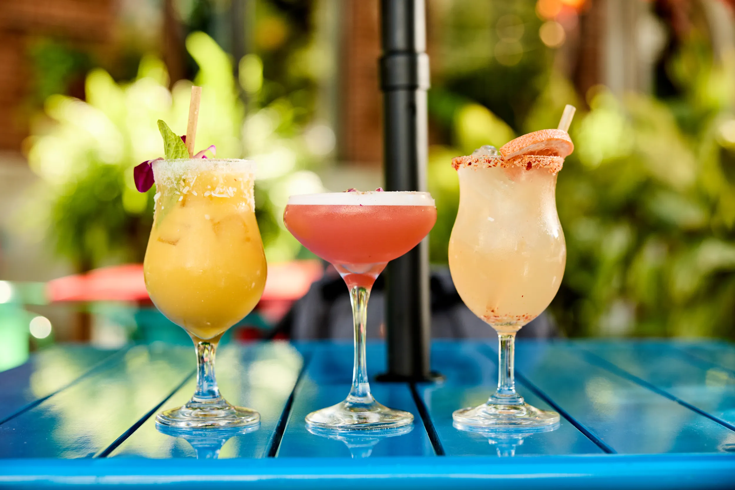 Three colorful non-alcoholic cocktails on a table at Thai Pop
