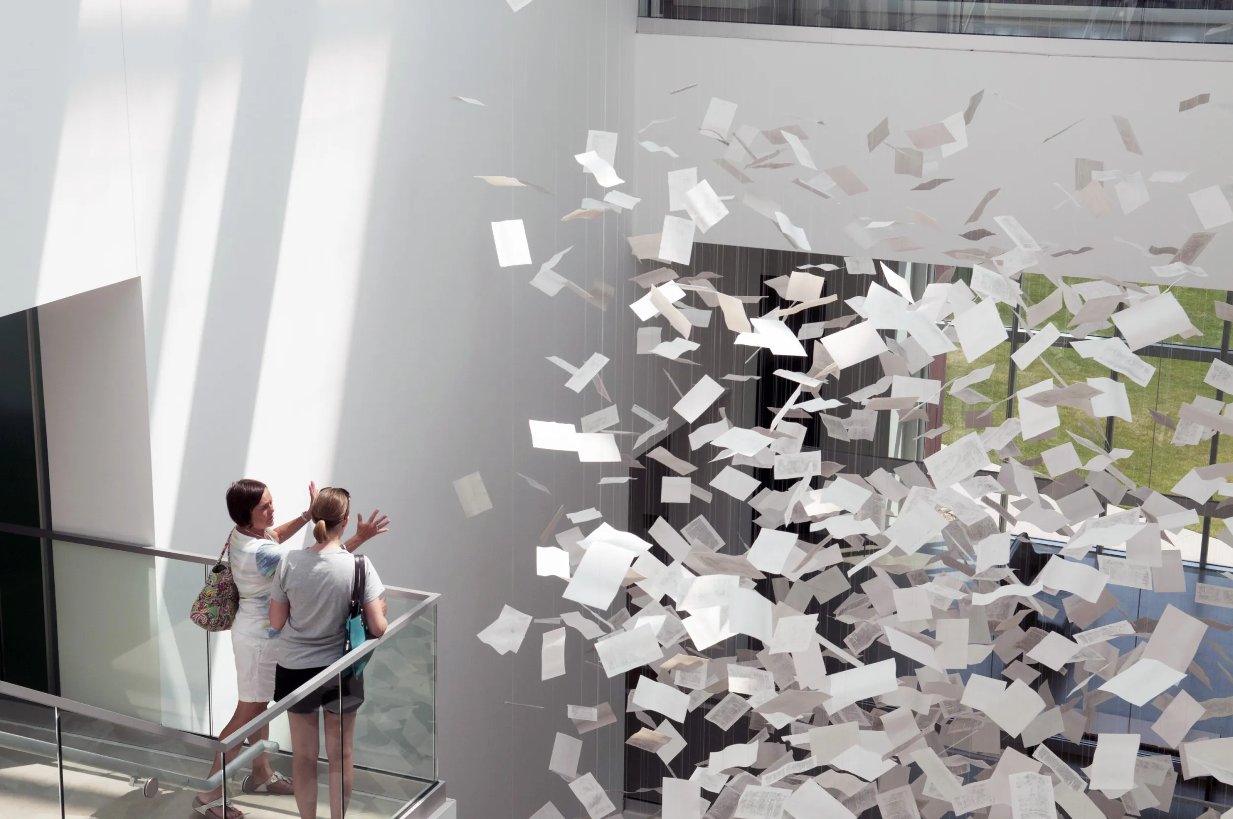 A couple friends look at an installation in the Rochester Art Center