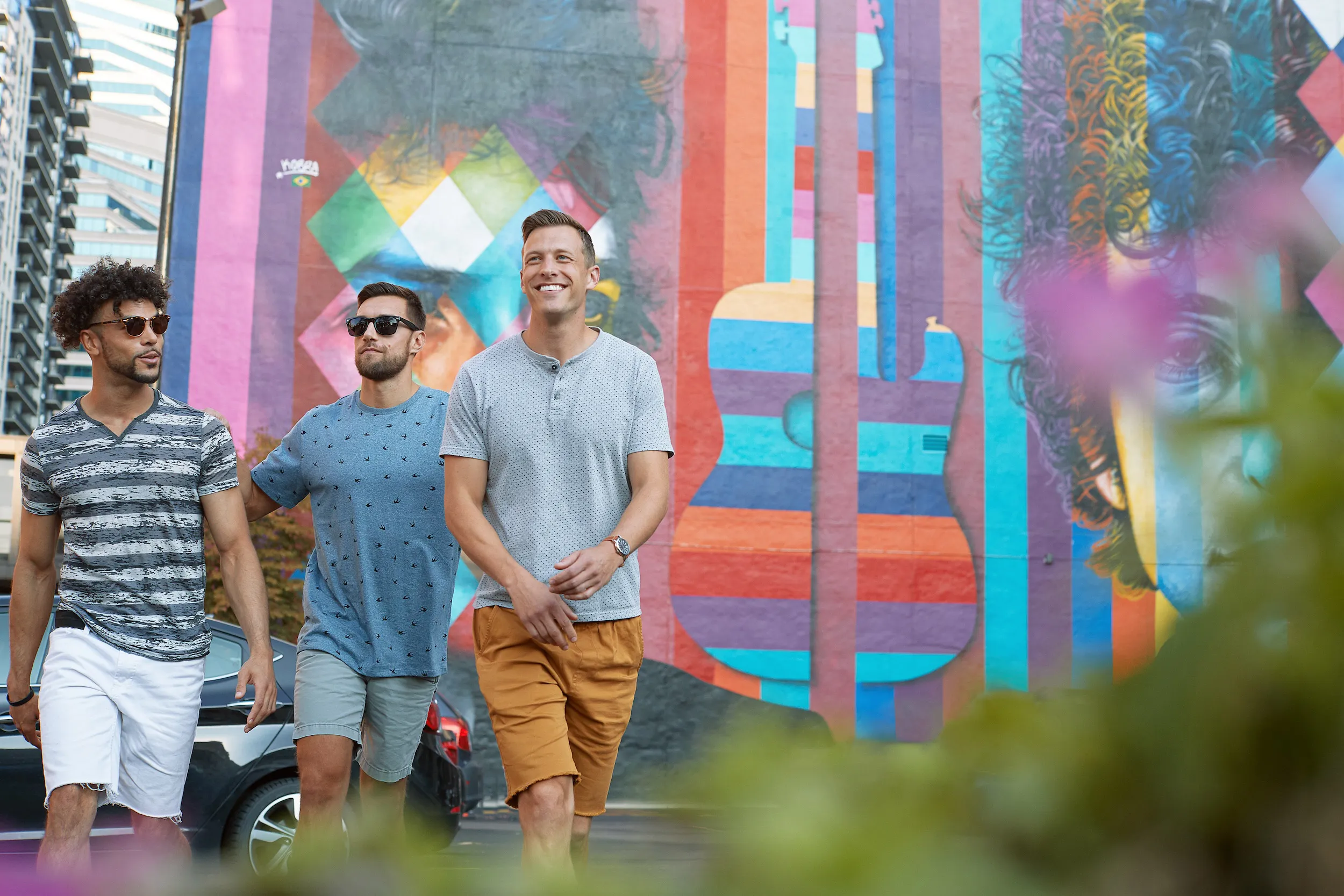 A group of friends walk past the Bob Dylan mural in downtown Minneapolis 