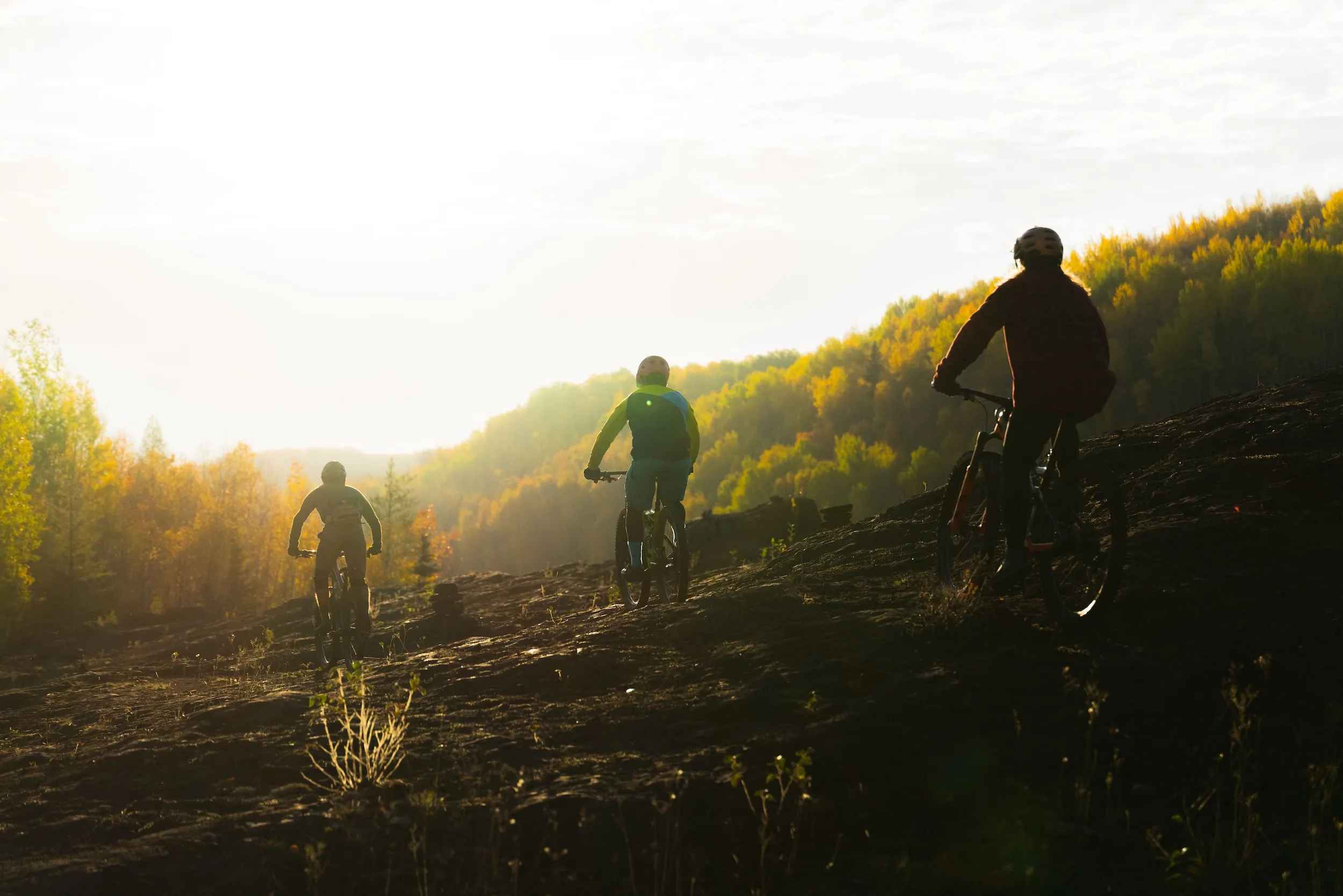 Mountain bikers on Redhead Mountain as the sun sets