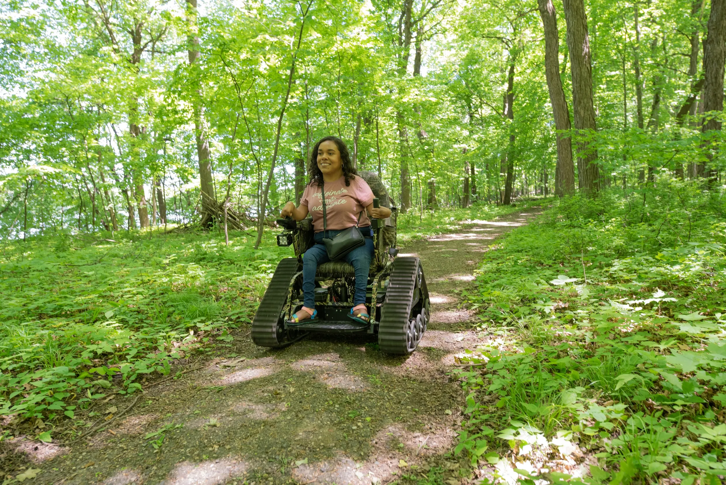 A woman rides in a track chair at Myre-Big Island State Park