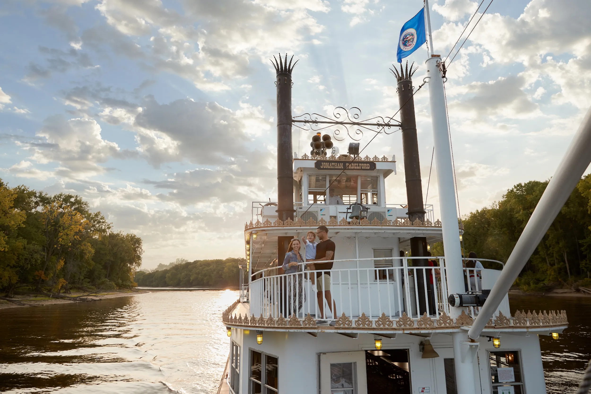 A family takes a riverboat cruise on the Mississippi River