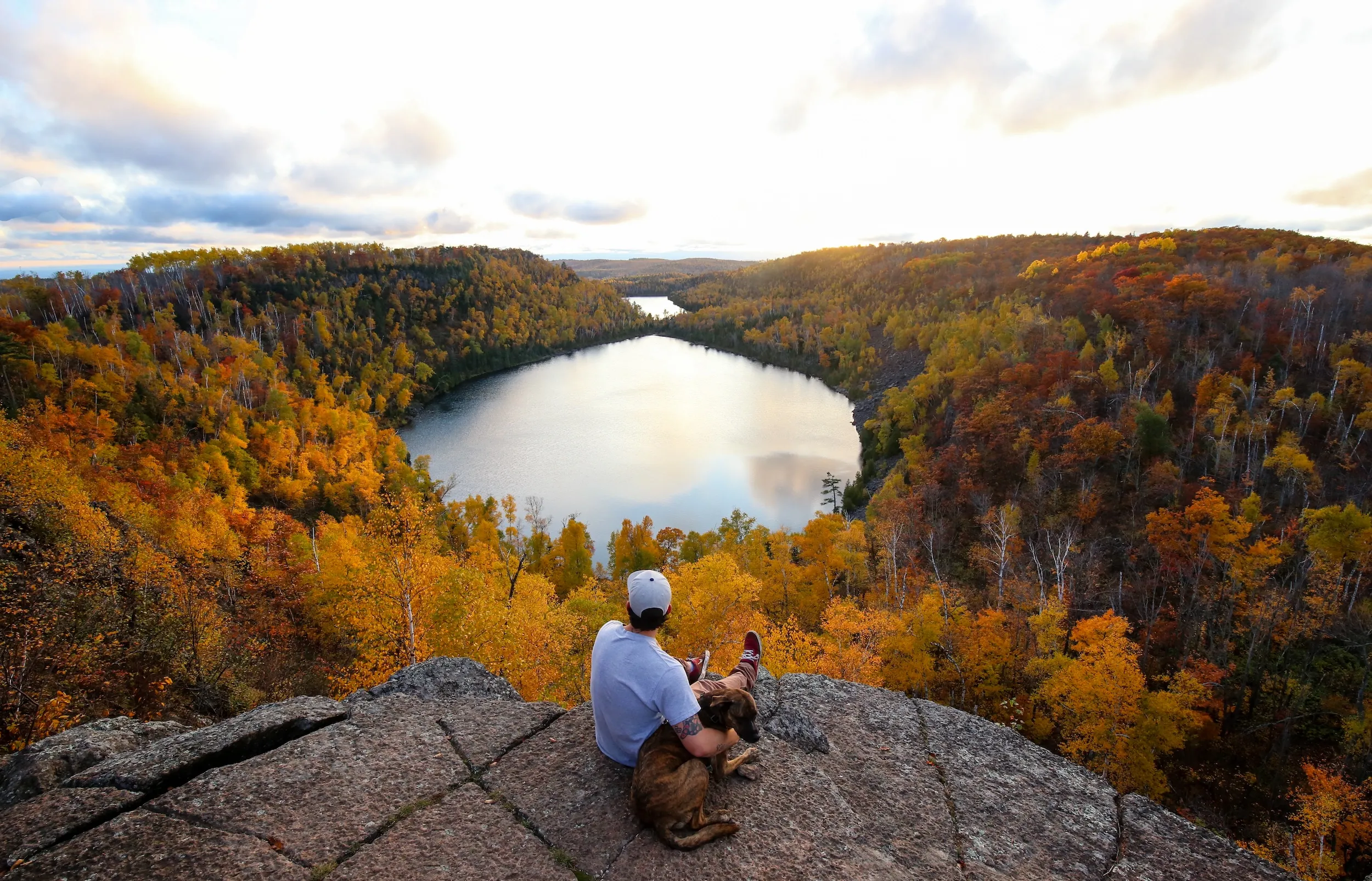 A man with his dog overlooking Bean Bear Lake along the Superior Hiking Trail