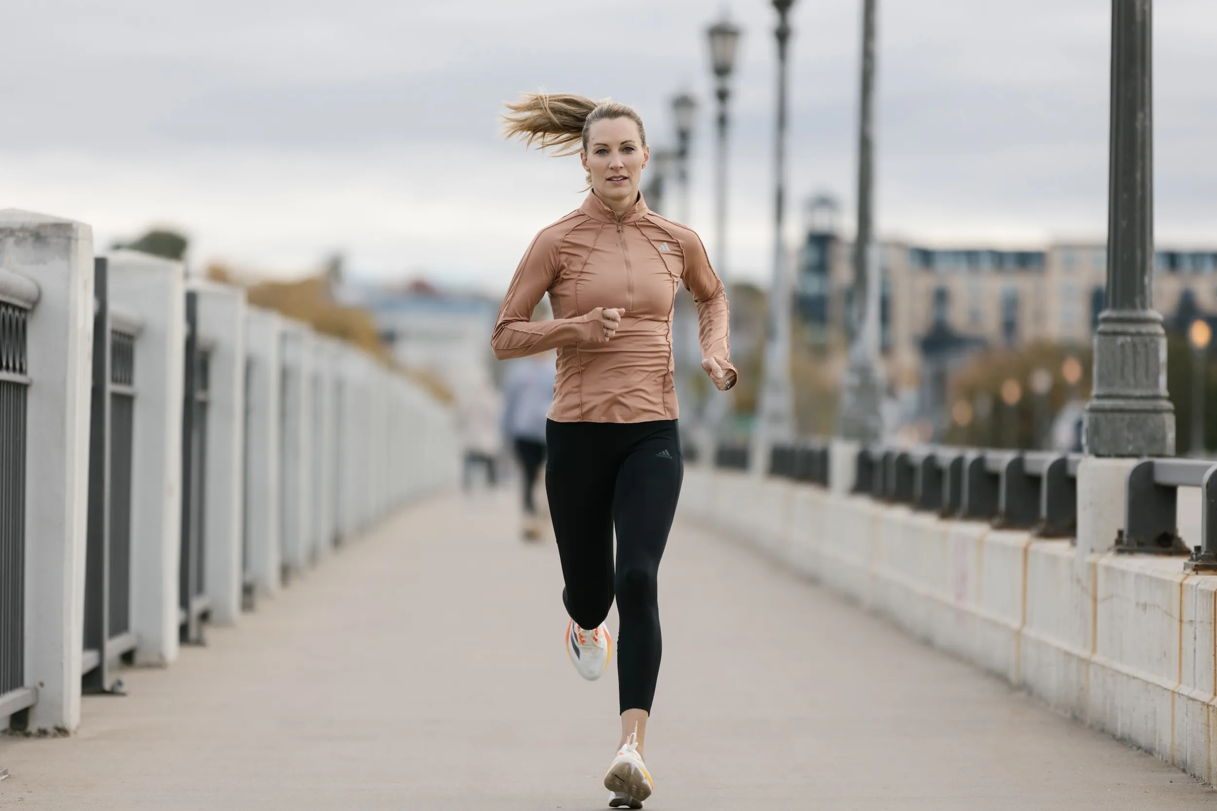 Carrie Tollefson runs on the Ford Parkway Bridge