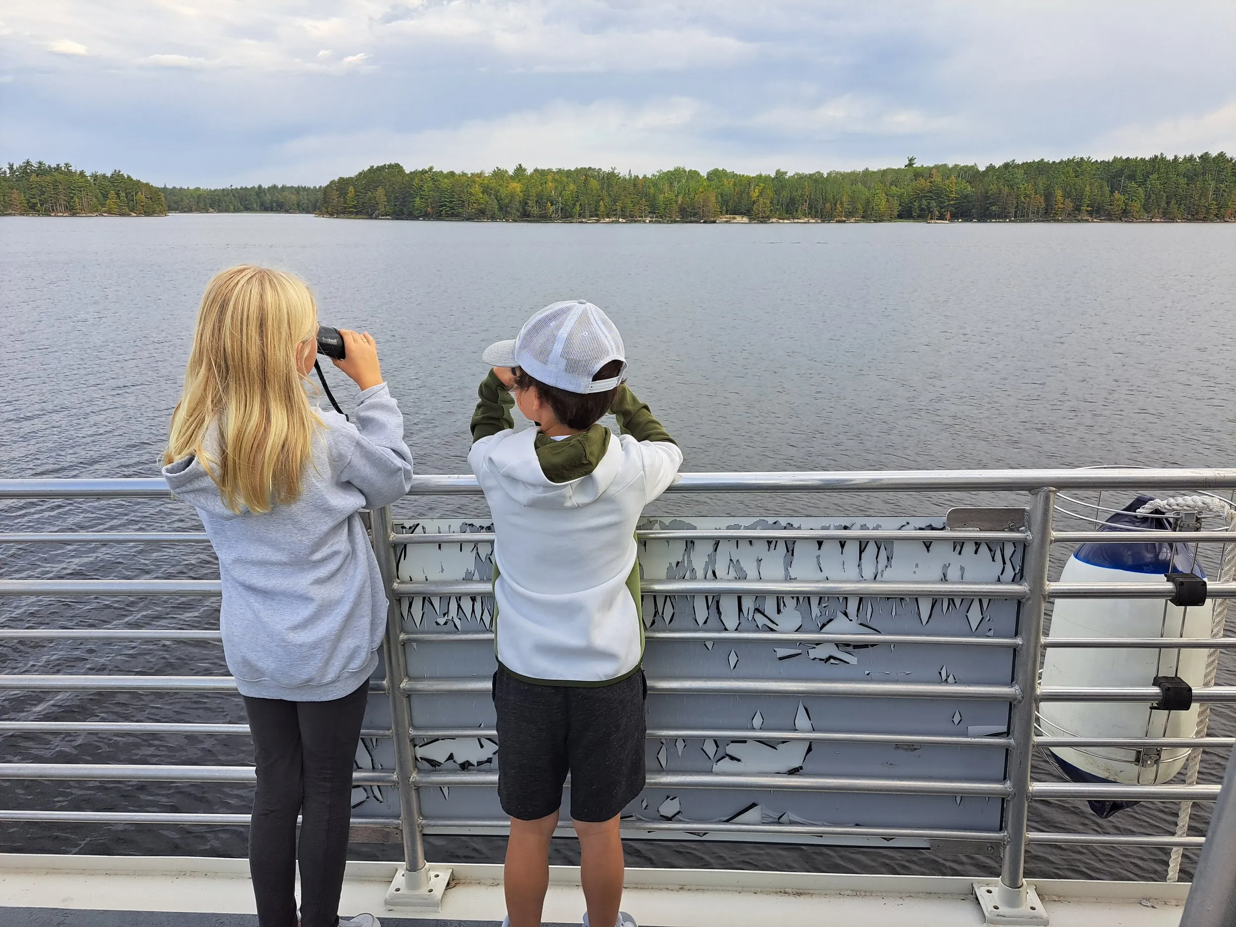 A couple kids look out at the water in Voyageurs National Park