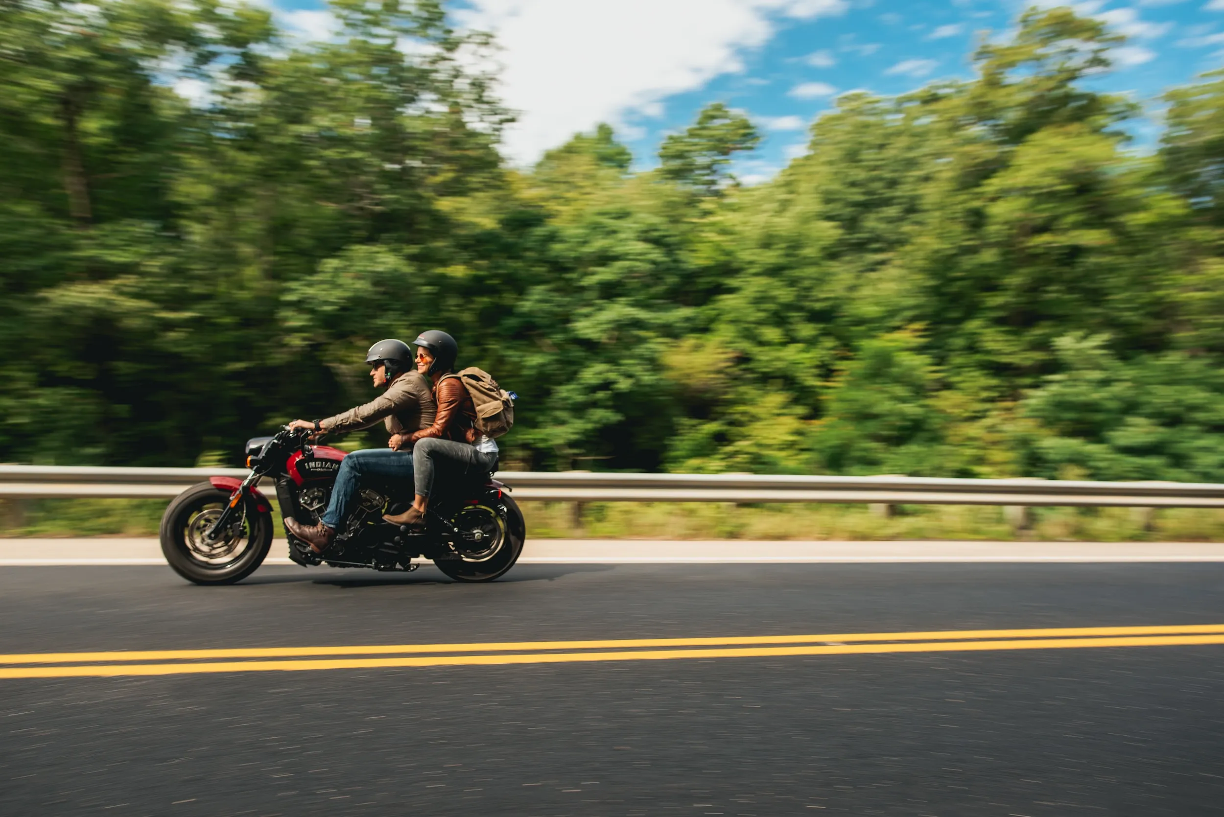 A couple rides a motorcycle through Red Wing