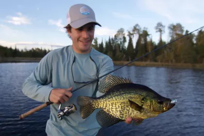 Man holds a crappie on a lake in Grand Rapids