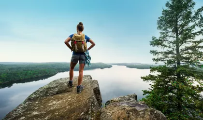 Female hiker at the top of Honeymoon Bluff in Grand Marais