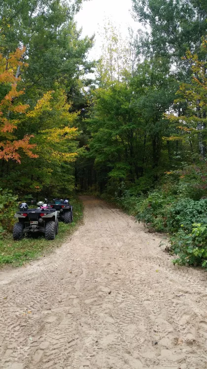 Two ATVs beside the Paul Bunyan State Forest trail