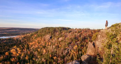 A hiker stands atop section 13 of the Superior Hiking Trail
