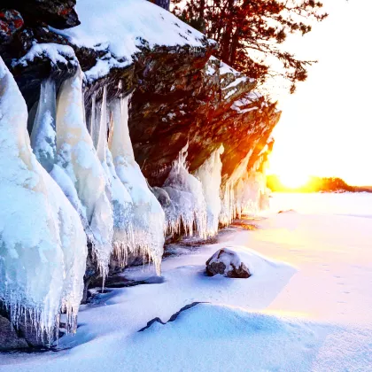 Sunrise over a snowy cliff in Voyageurs National Park