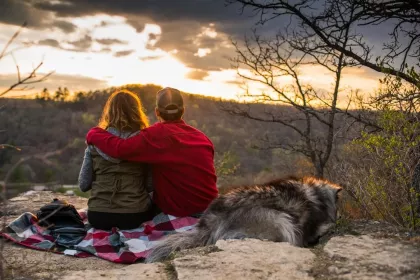 Couple and dog on scenic overlook
