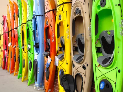 Rainbow of kayaks lined up outside Reeds Sporting Goods