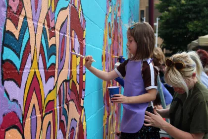 Kids painting Old Town Mankato mural