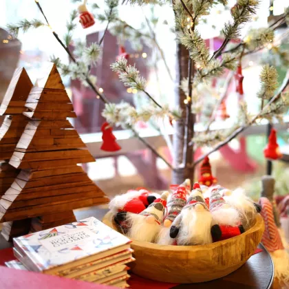 Holiday display with wooden Christmas trees and gnomes
