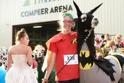 Llama and trainer in Batman and Robin costumes