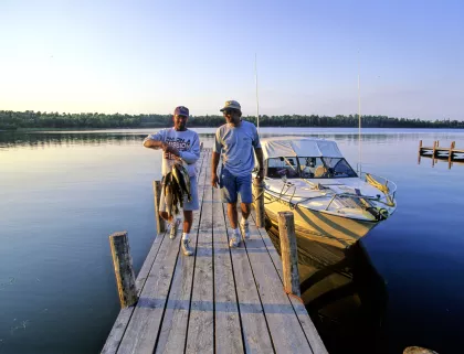 Lake of the Woods holding stringer of fish on dock Hennum's Oak Island Resort