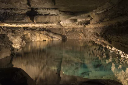 Turquoise-colored underground lake in a cave.