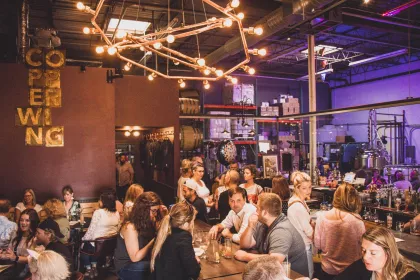 Interior of Copperwing Distillery on a busy evening