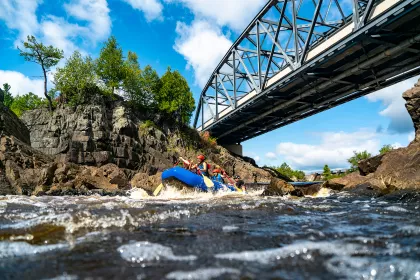 A family enjoys swiftwater rafting in Jay Cooke State Park, Carlton