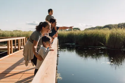 A family on a wood boardwalk at Wood Lake Nature Center