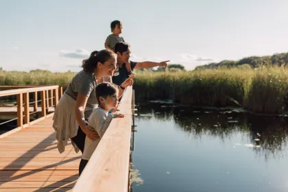 A family on a wood boardwalk at Wood Lake Nature Center