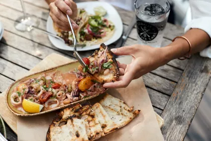 Plat of food handled by a man at the Birch's on the Lake Brewhouse &amp; Supperclub