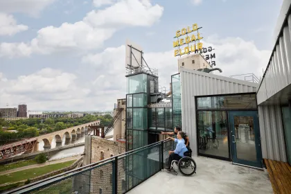A couple looks at the Minneapolis skyline from the Mill City Museum observation deck