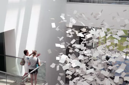 A couple friends look at an installation in the Rochester Art Center