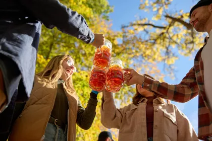A group of friends toast their steins at Schell's Oktoberfest