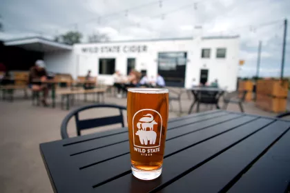 A pint of cider on a patio table at Wild State in Duluth