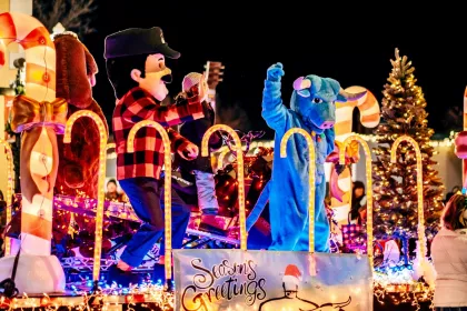 Paul Bunyan and Babe the Blue Ox costumed characters on a parade float at the Night We Light Parade in Bemidji