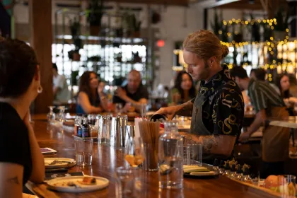A bartender pours a cocktail at Earl Giles Distillery