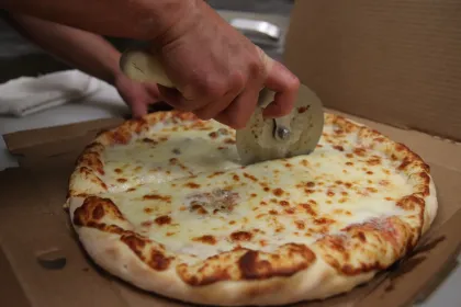 Pizza being cut at Jake's Pizza