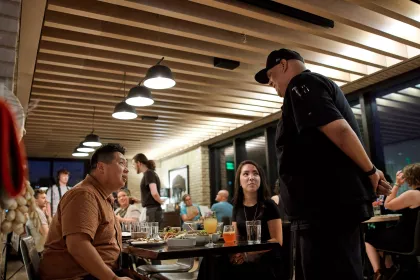 A couple friends chat with the chef at Owamni