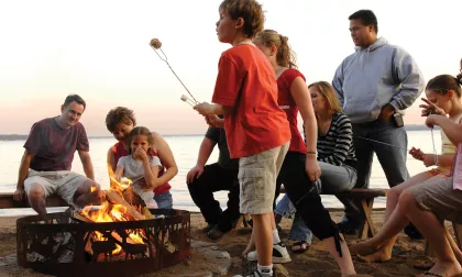A family gathers around a bonfire at Grand View Lodge