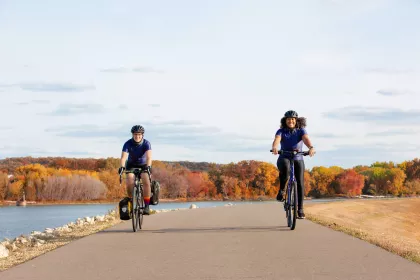 Two women bike along the Mississippi River Trail in South St. Paul
