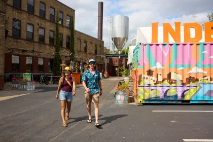 A couple walks outside Indeed Brewing in Northeast Minneapolis