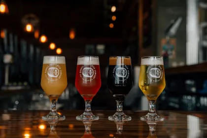 A row of four pints atop Barrel Theory's bar