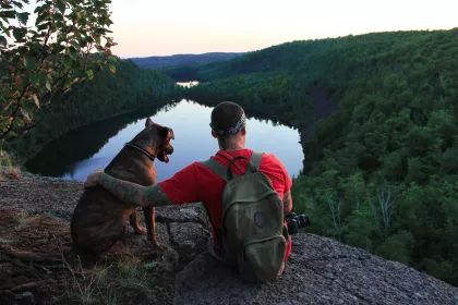 A hiker and his dog look at Bean and Bear Lakes