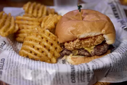 A burger and waffle fries at King's Place Bar and Grill