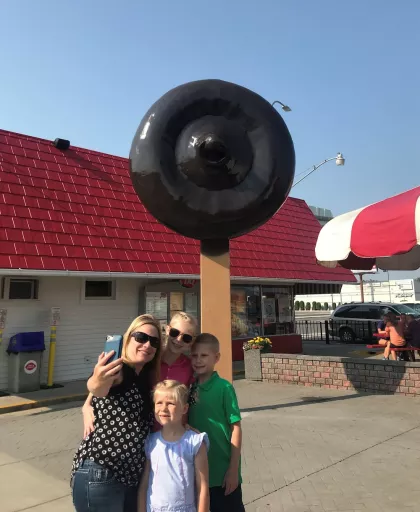 A family takes a selfie outside the World's Largest Dilly Bar in Moorhead