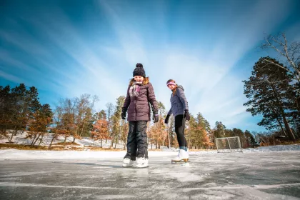 A couple ice skaters at Boyd Lodge in Crosslake