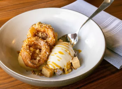 Poached apples with a spiced donut, hazelnuts and sunchoke ice cream at Bûcheron