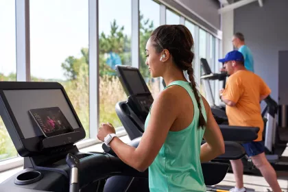 A woman runs on a treadmill at Anytime Fitness
