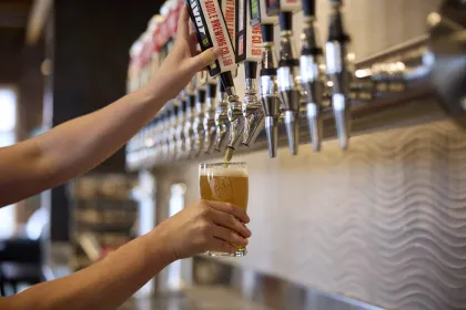 A bartender pours a pint at Bent Paddle