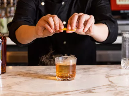 A bartender preps a cocktail at Breva